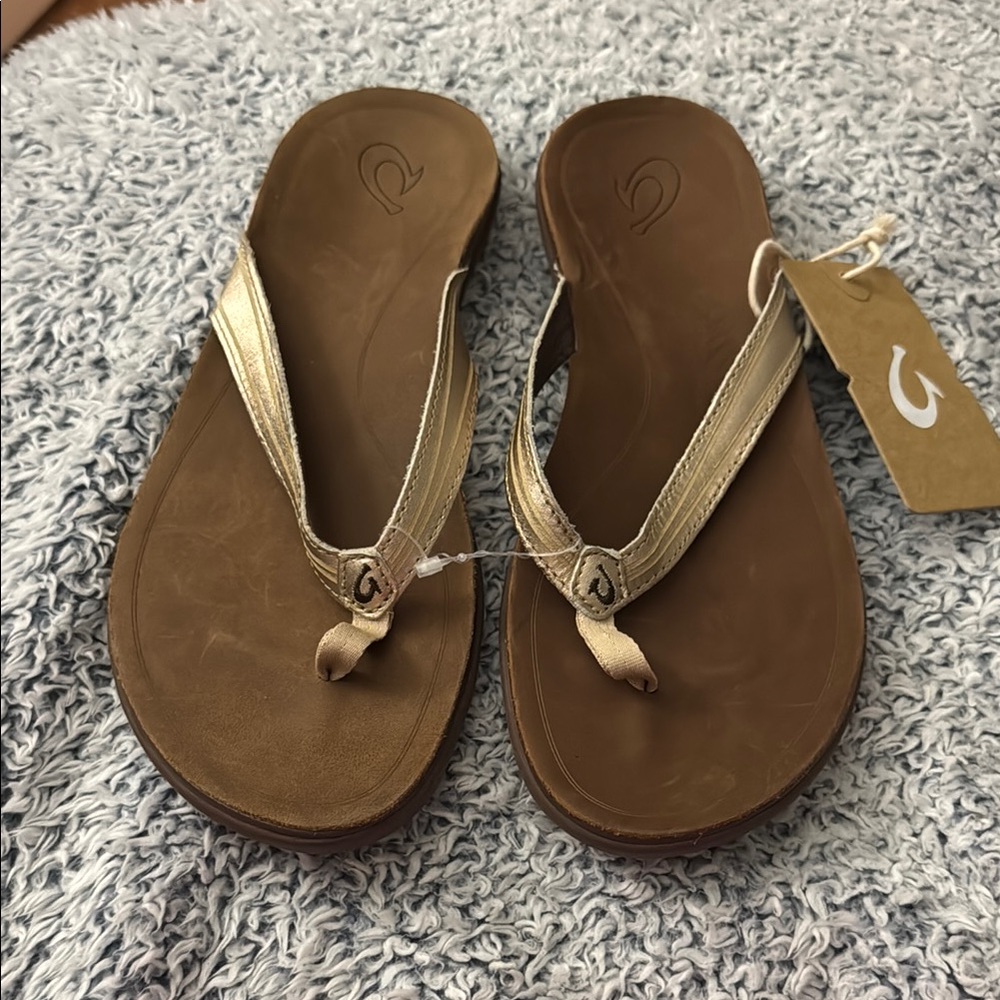 New! Olukai Brown and Gold Flip Flops